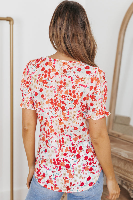 Blusa floral con mangas de burbuja y volantes 