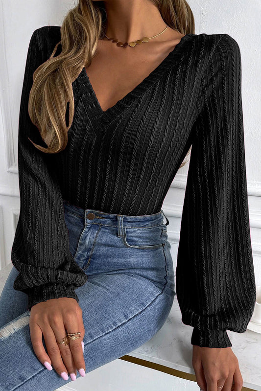 Top de manga farol con cuello en V de jacquard de punto negro