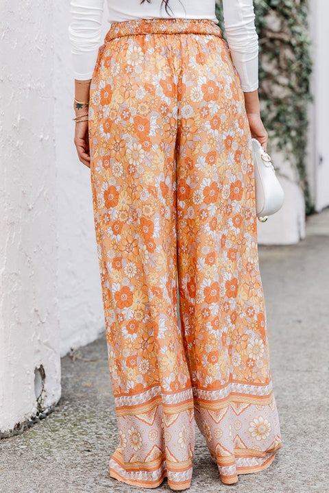 Pantalones anchos con estampado floral bohemio y cintura anudada en naranja pomelo