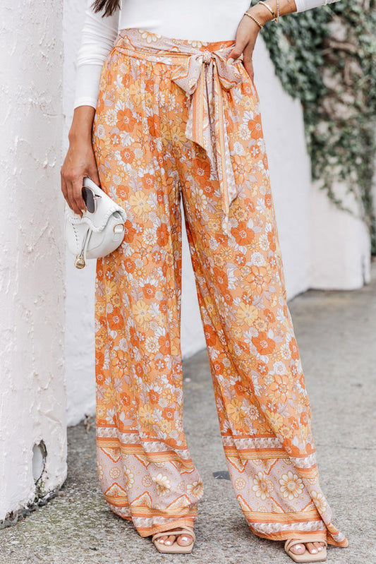 Pantalones anchos con estampado floral bohemio y cintura anudada en naranja pomelo